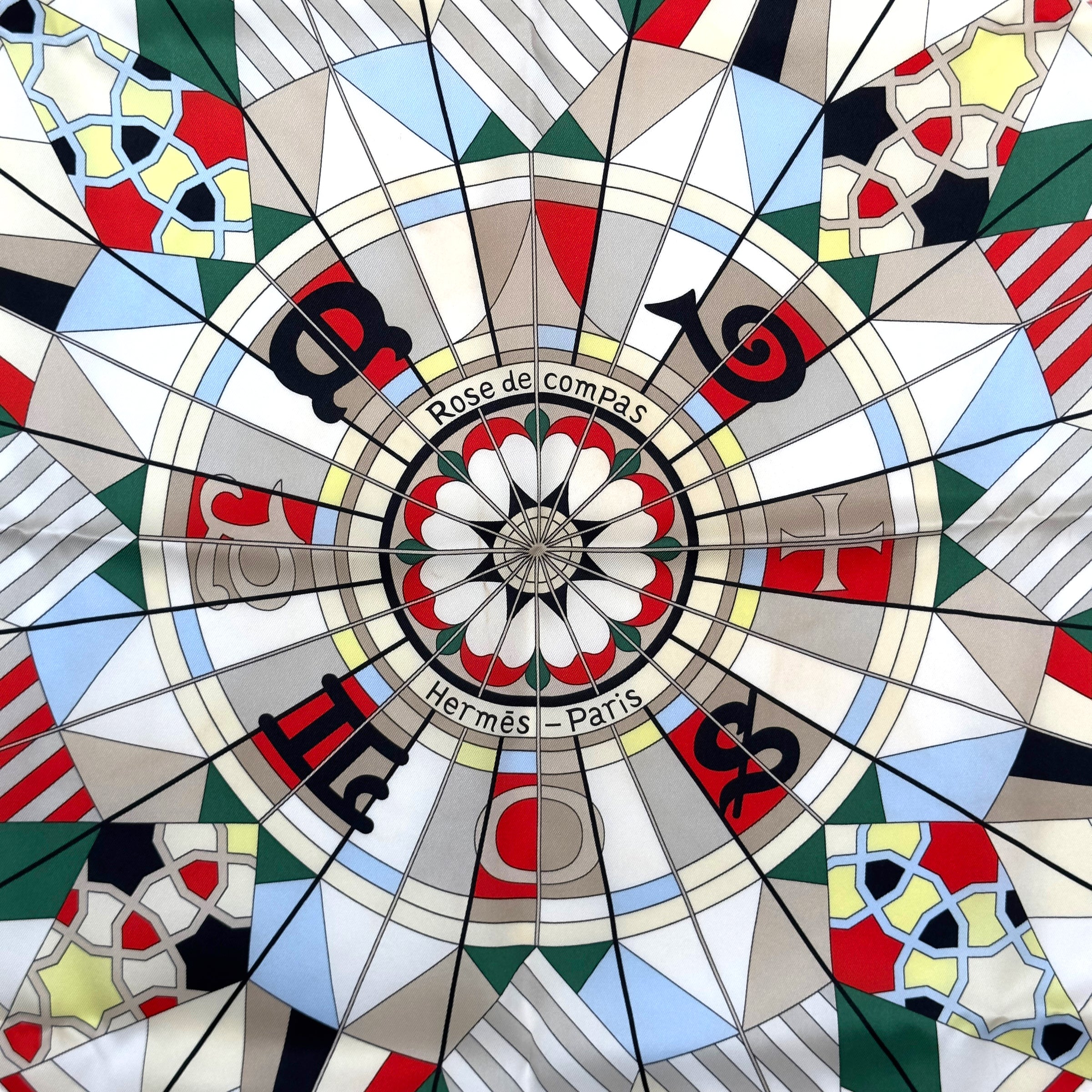 Foulard Carre Hermes en 100% soie de 70cm représentant rose de compas multicolore vendu par la boutique Carre Society à Paris specialiste du foulard hermes de seconde main dessin Natsuno Hidaka